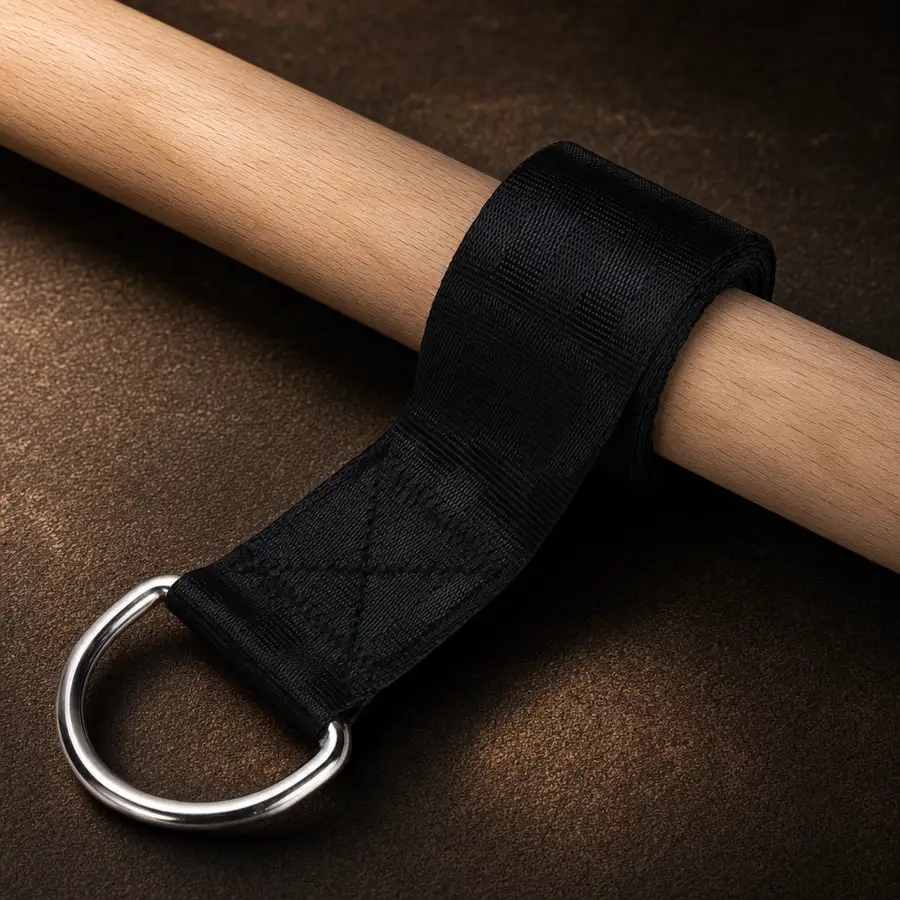 Close-up of the stitched strap loop and steel D-ring around the wooden handle