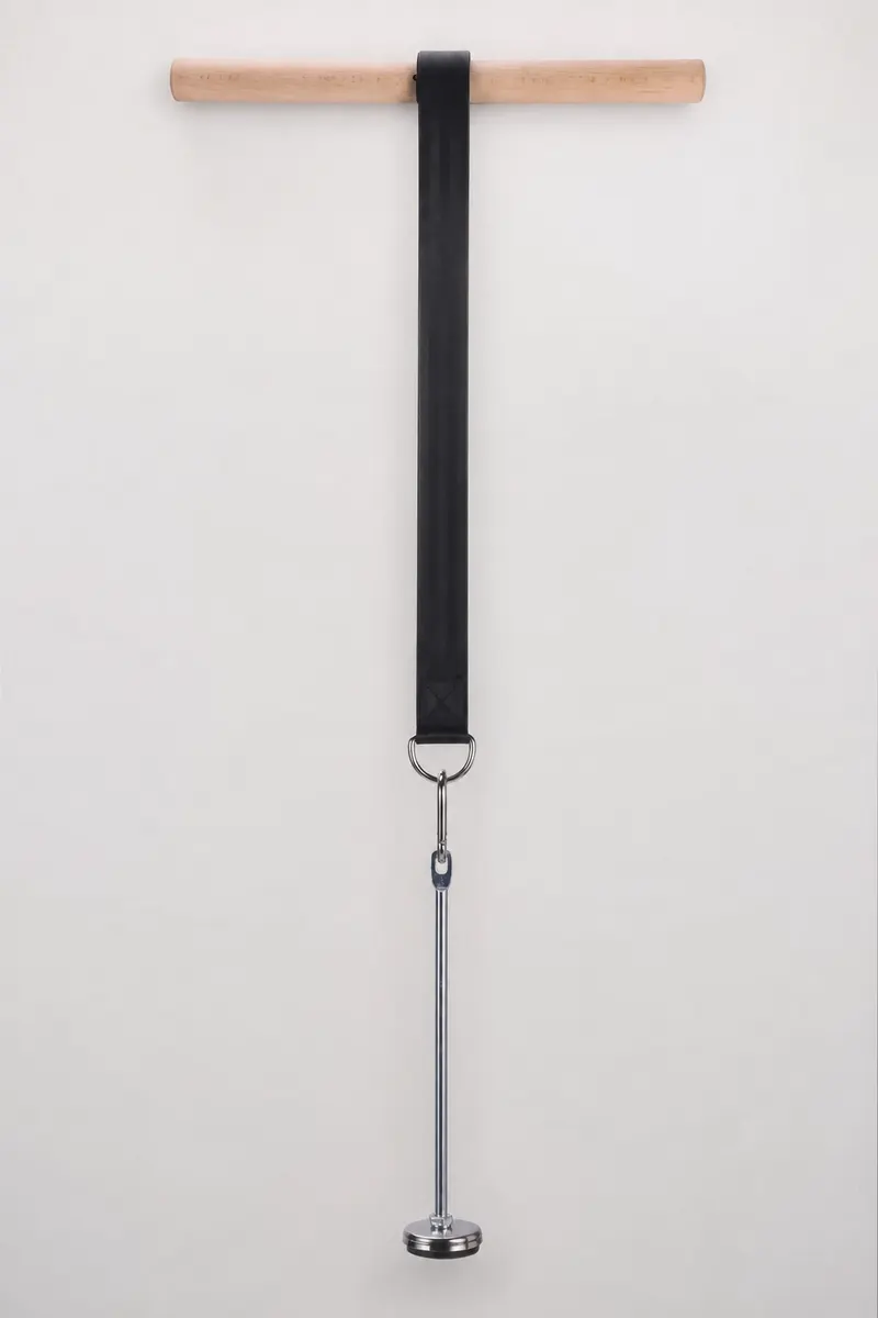 Wrist roller hanging vertically with strap extended and loading pin clipped to the carabiner