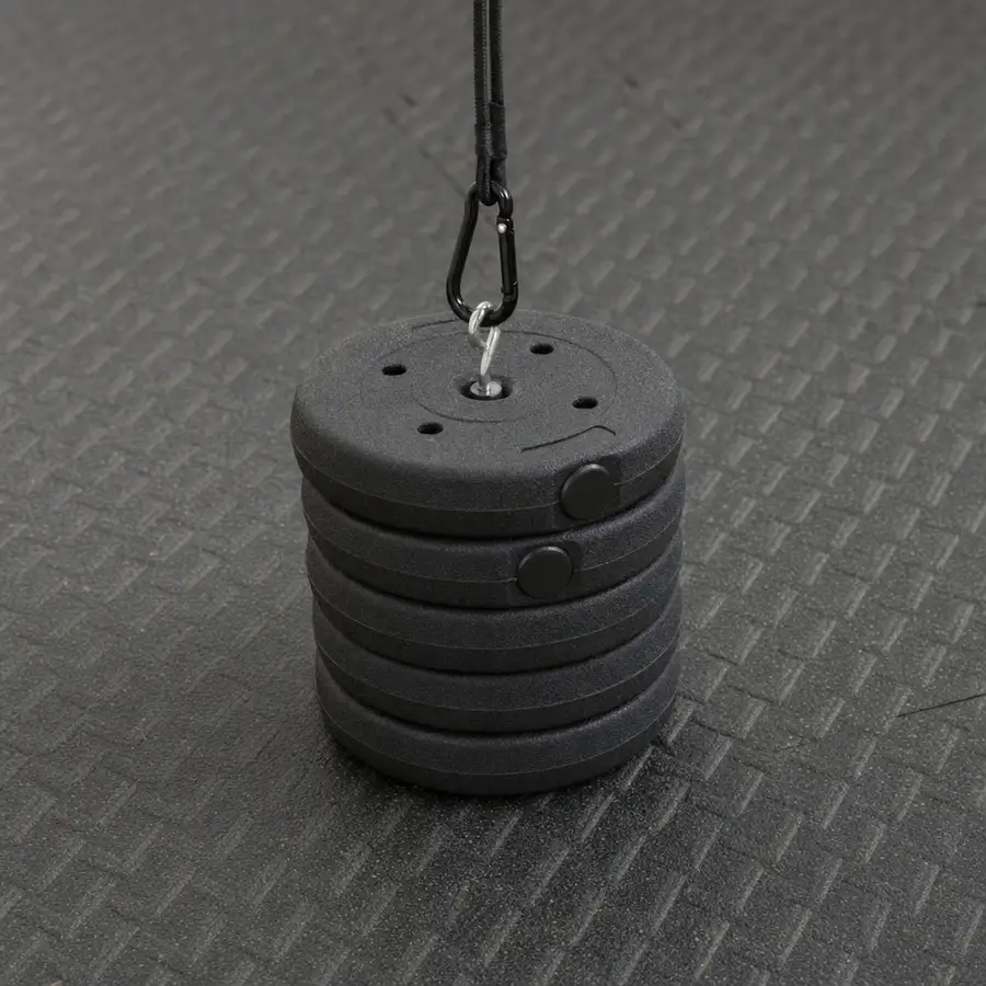 Loading pin stacked with weight plates, clipped by a carabiner on a rubber gym mat